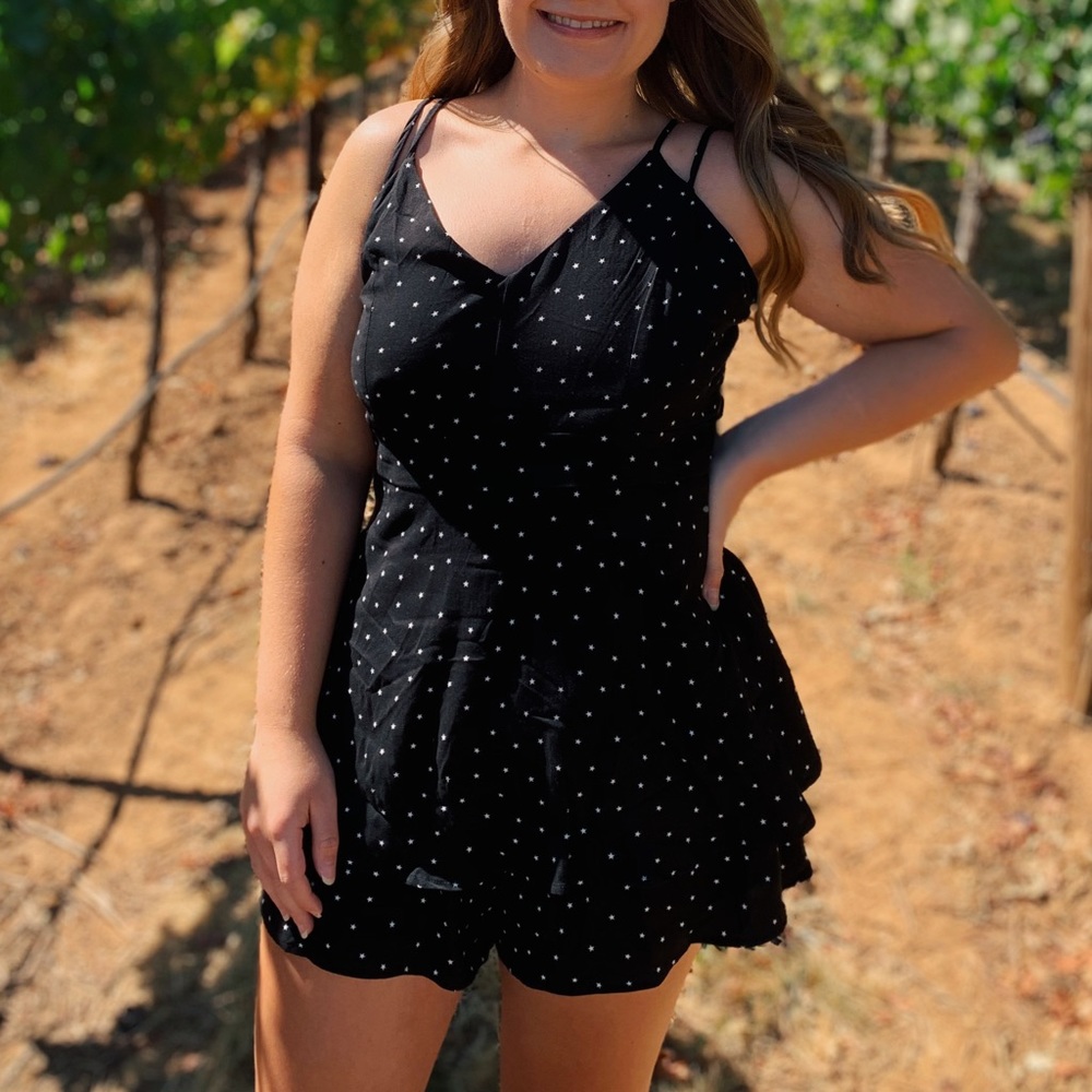 Black star patterned ruffled romper